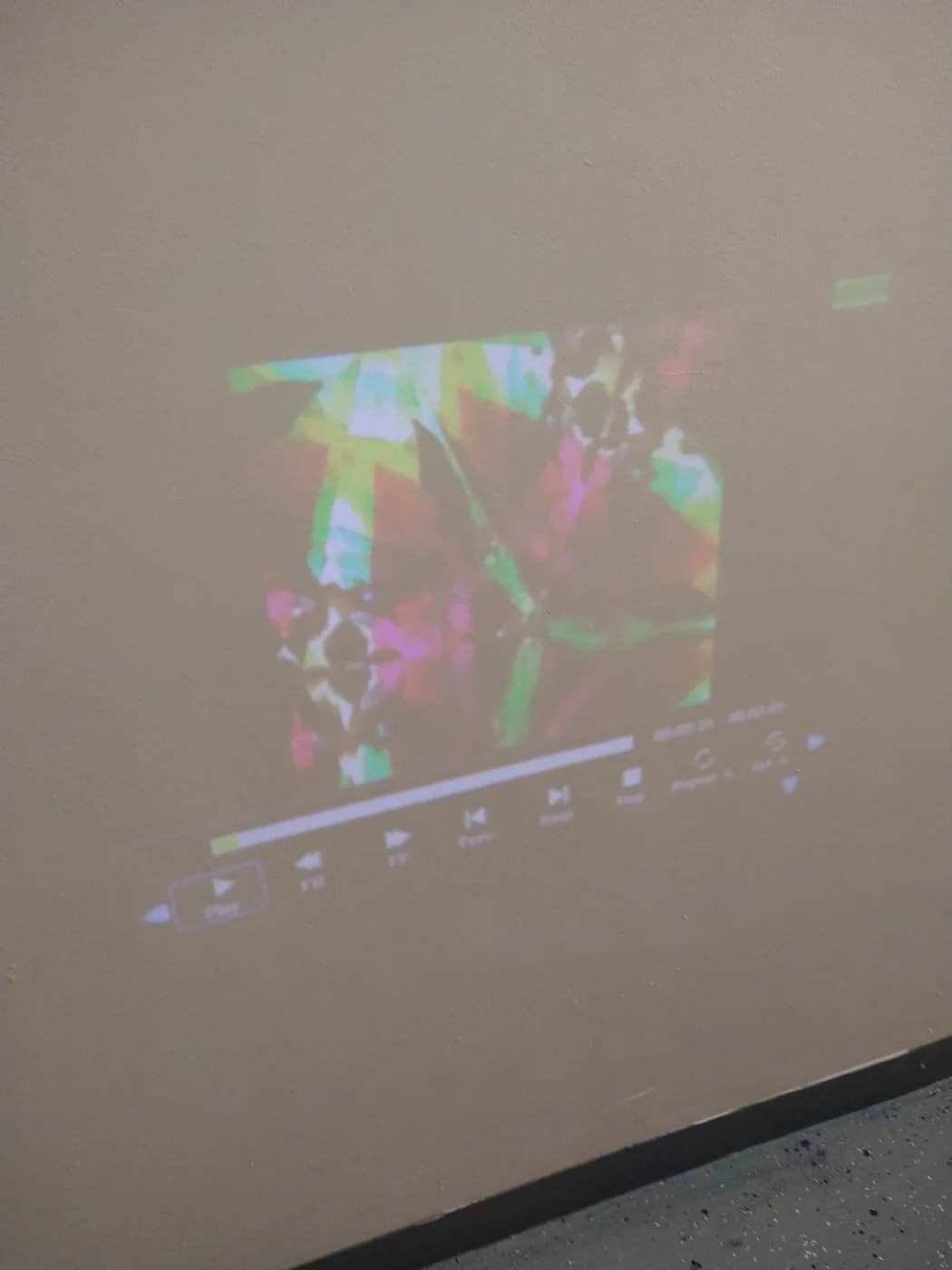 Kaleidoscope patterns projected across a wall