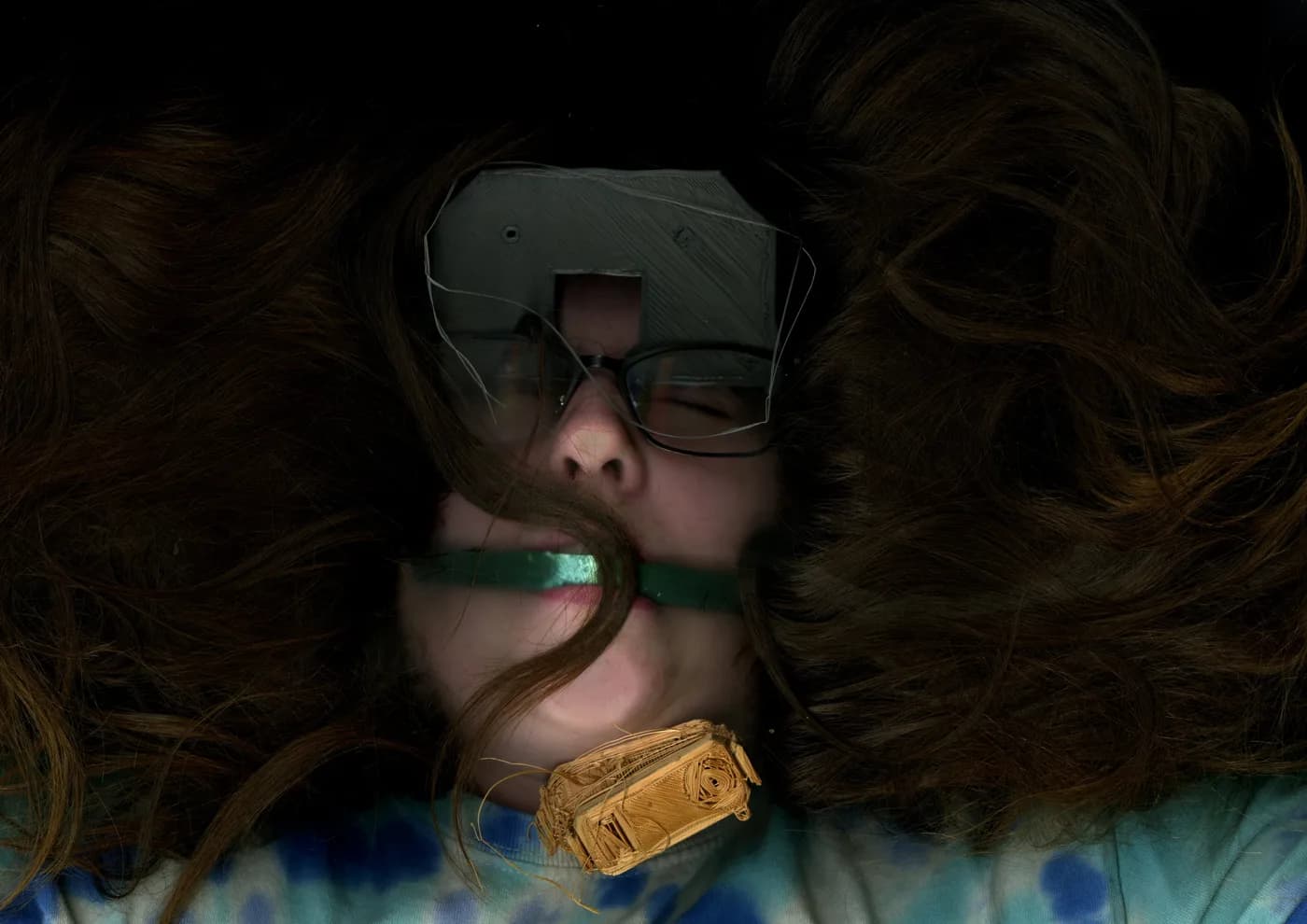 Face resting on the scanner, hair spread like a halo