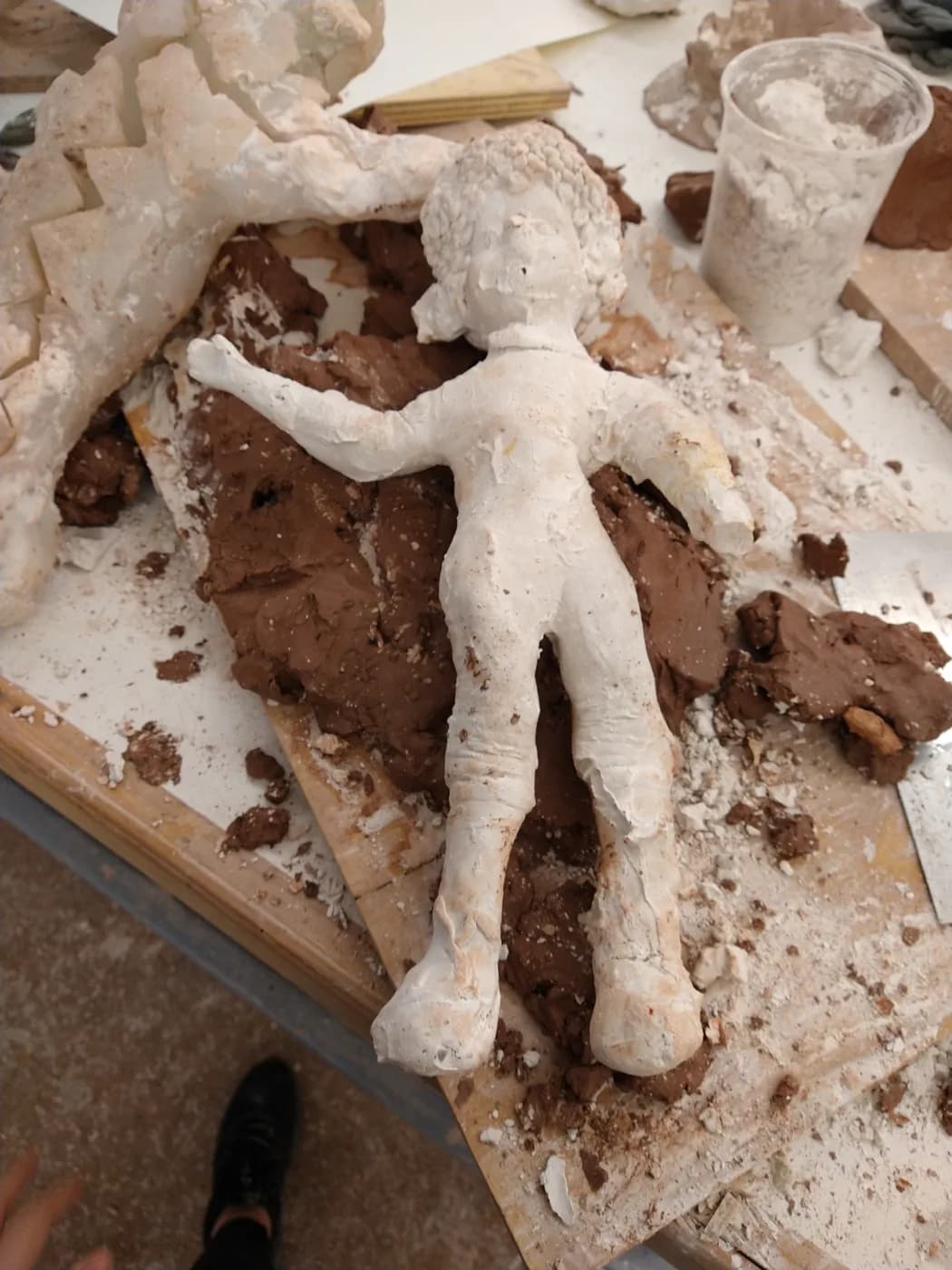 The plaster figure in its casting mold