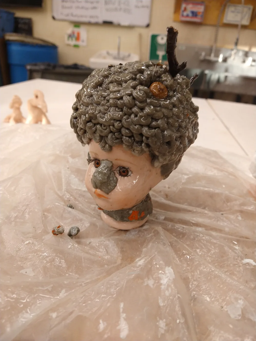 A glazed ceramic head with curly hair