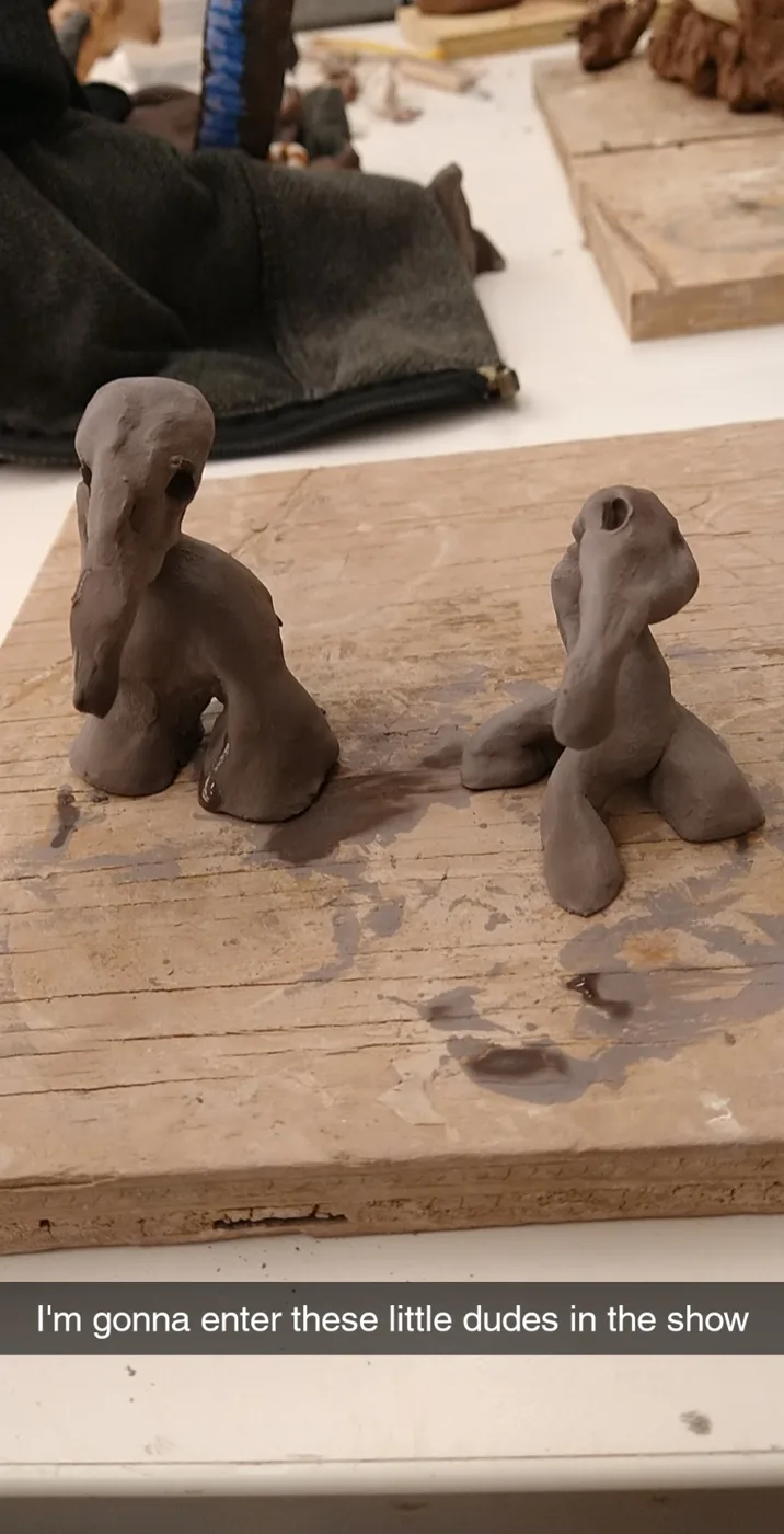 Two small clay creatures before glazing