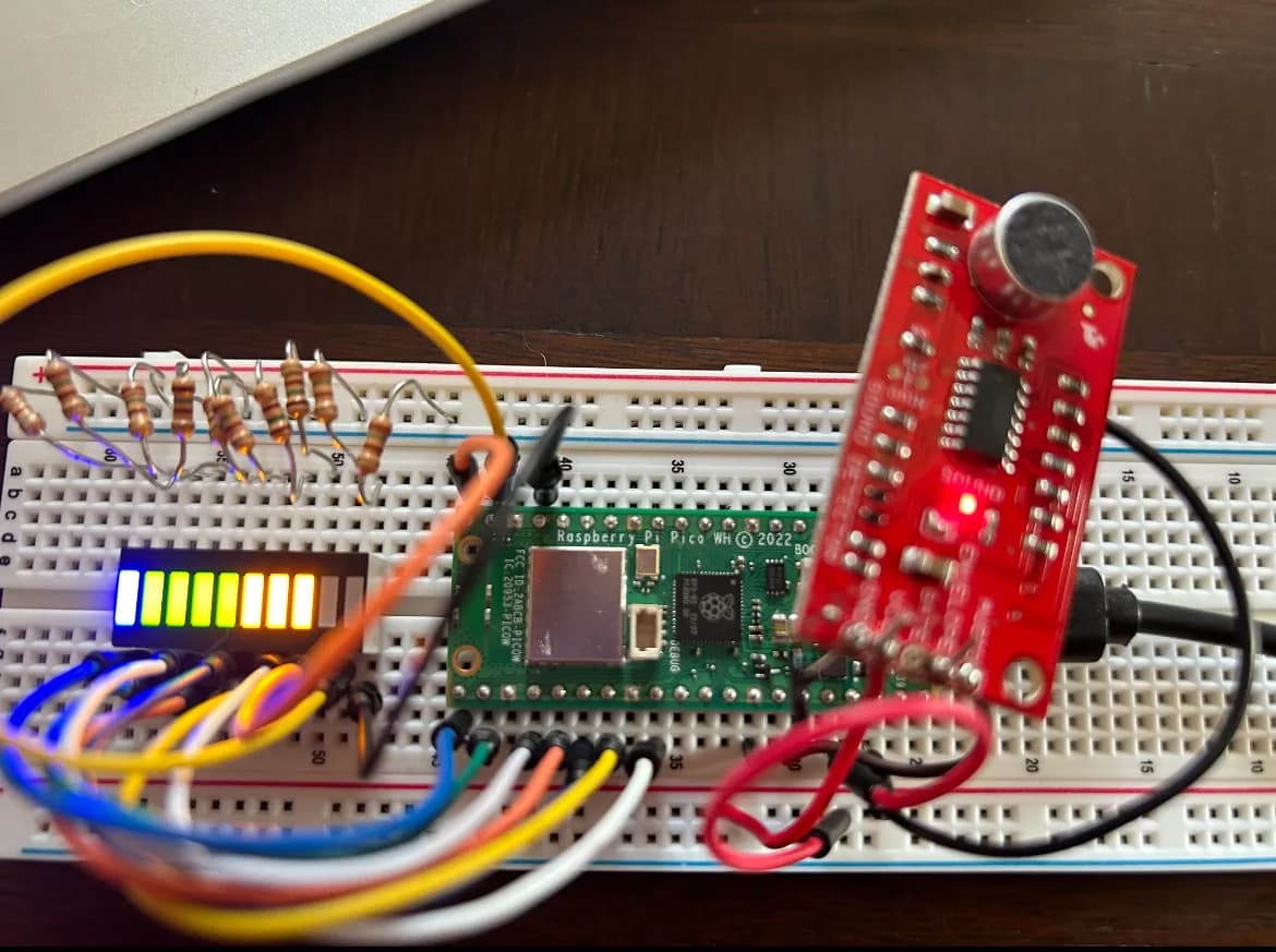 Breadboard with the Pico, the SparkFun sound detector, and the LED bar graph lit up after a bark