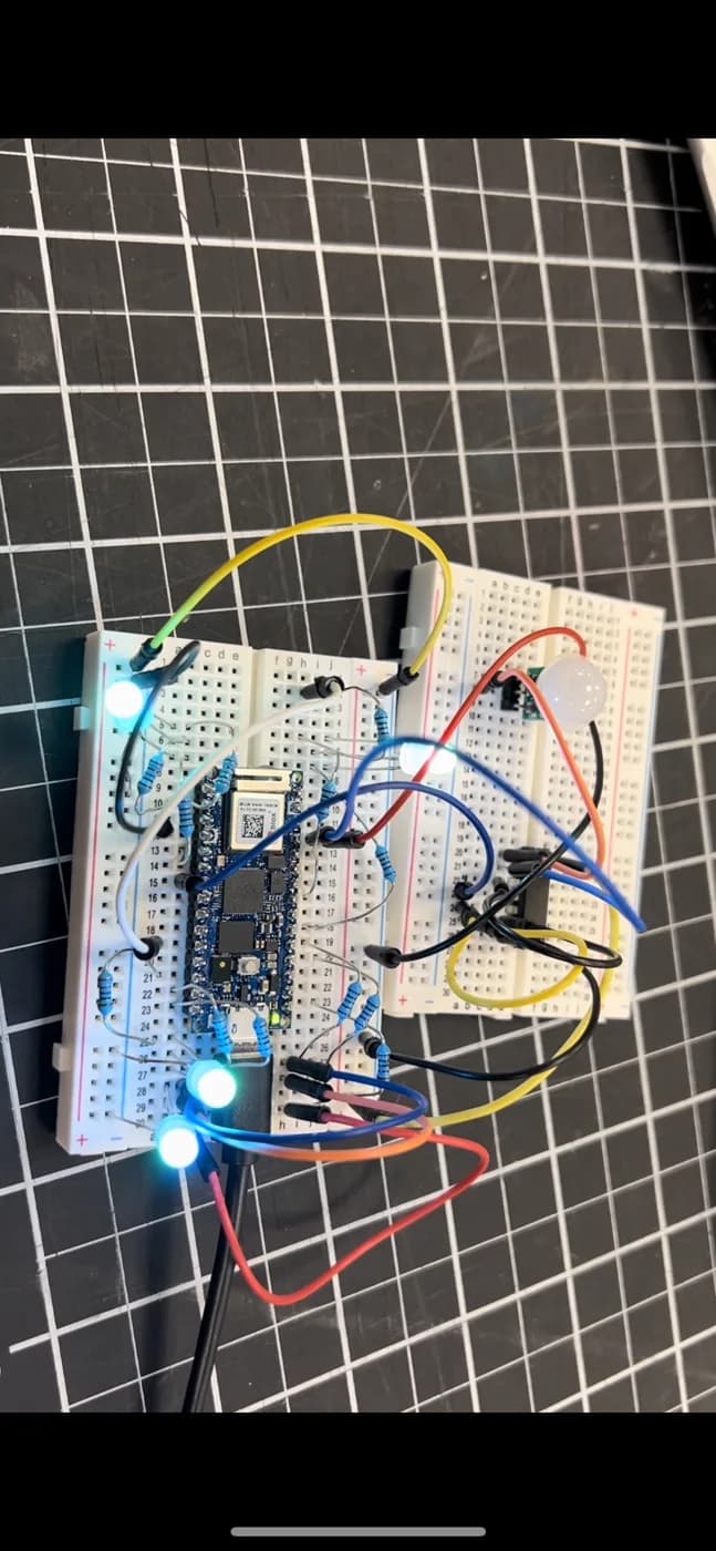 Breadboard prototype with the motion sensor wired in and the LEDs lit